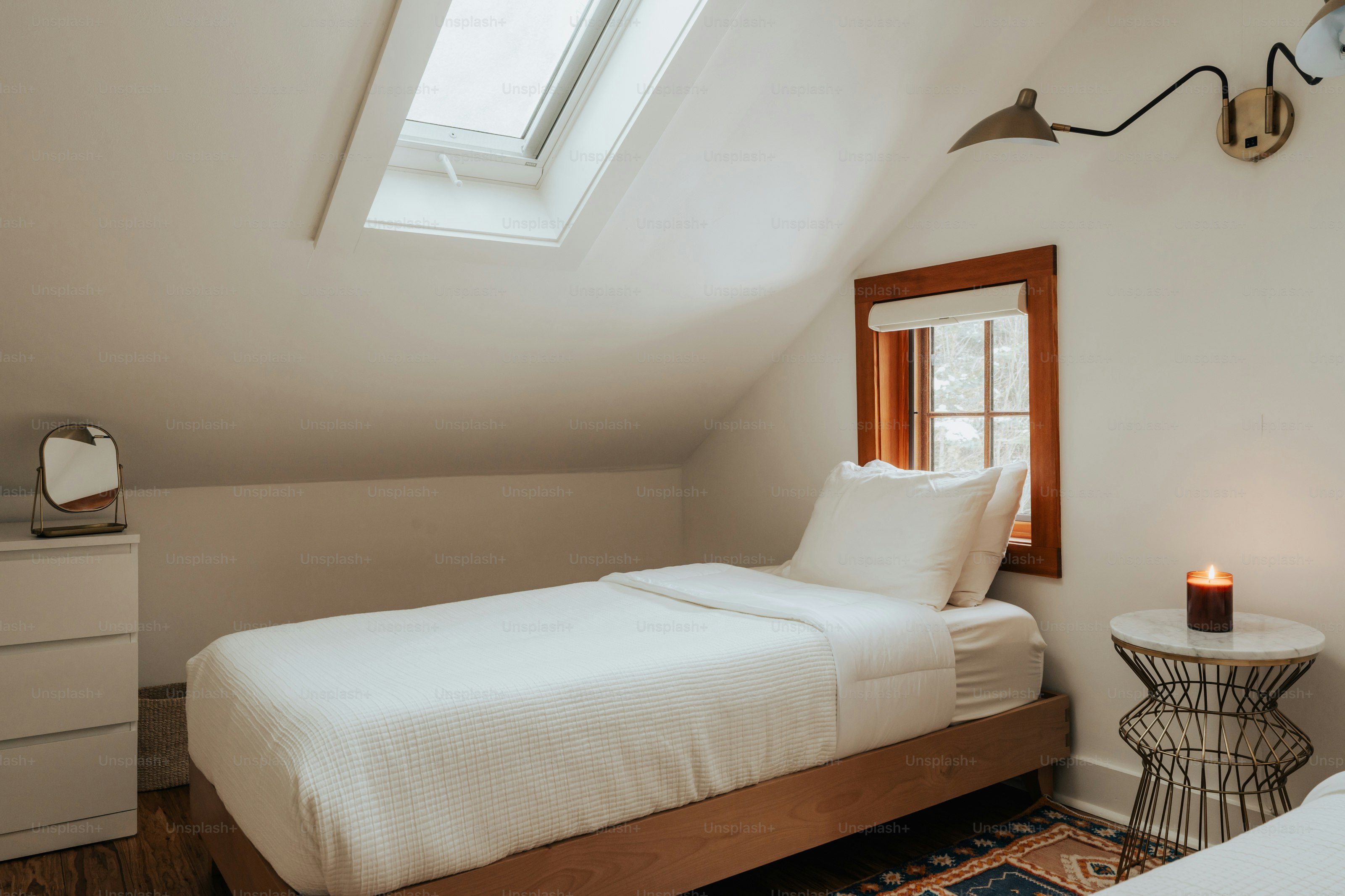 A bedroom with two beds and a window